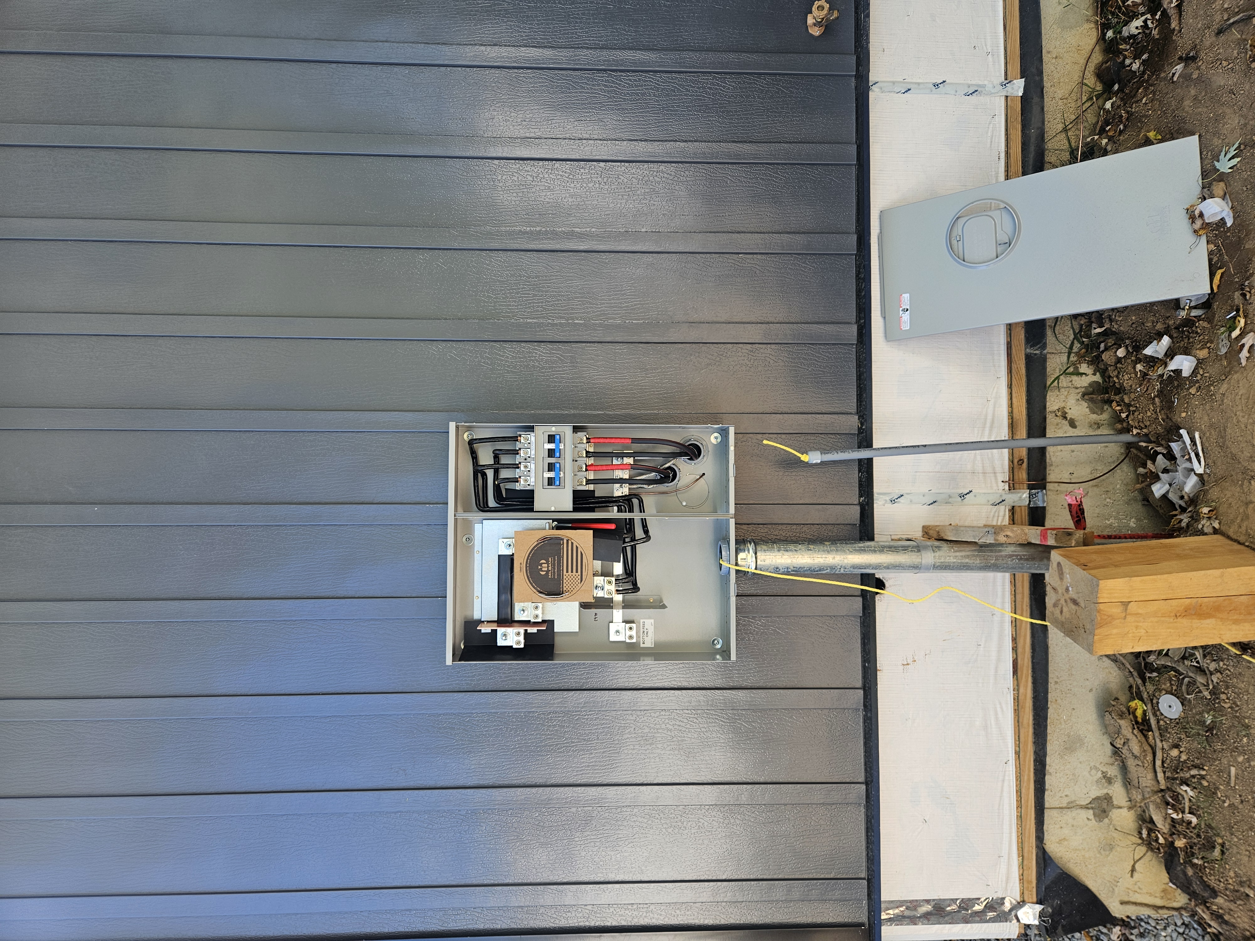 Outdoor Milbank electrical meter socket and breaker panel on home exterior